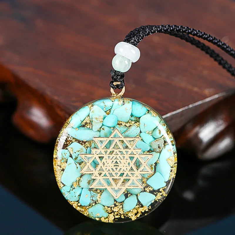A handcrafted seven chakra pendant necklace made with crushed turquoise, designed to promote positive energy and spiritual alignment.