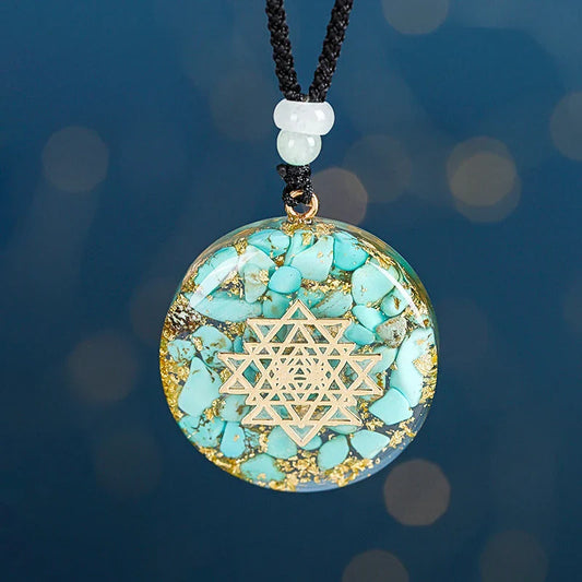 A handcrafted seven chakra pendant necklace made with crushed turquoise, designed to promote positive energy and spiritual alignment.