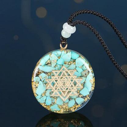 A handcrafted seven chakra pendant necklace made with crushed turquoise, designed to promote positive energy and spiritual alignment.