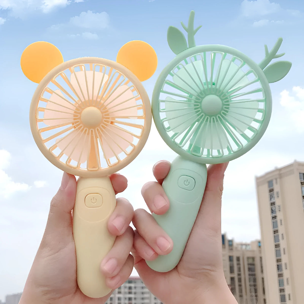 Small handheld cartoon-style USB charging fan in blue, green, pink, or yellow colours.