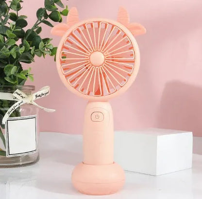 Small handheld cartoon-style USB charging fan in blue, green, pink, or yellow colours.