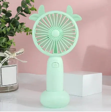 Hand-held small fan with USB charging for students, featuring a portable cartoon-style design in multiple colours, offering 1-2 hours of battery life per charge, with a round plastic blade and compact size for personal cooling.