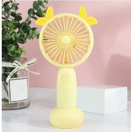 Small handheld cartoon-style USB charging fan in blue, green, pink, or yellow colours.