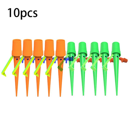 Green and orange plastic garden watering spikes measuring 16.5cm for plant irrigation