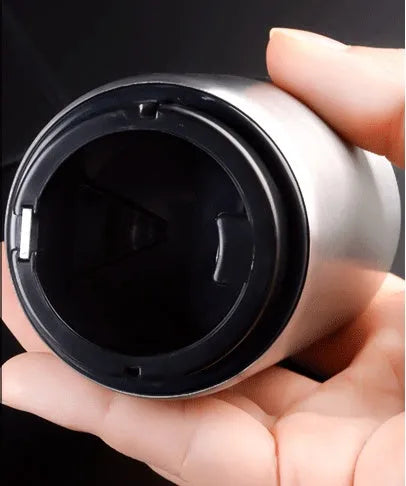 Stainless steel automatic bottle opener measuring 8.4 cm by 5.3 cm on a kitchen counter