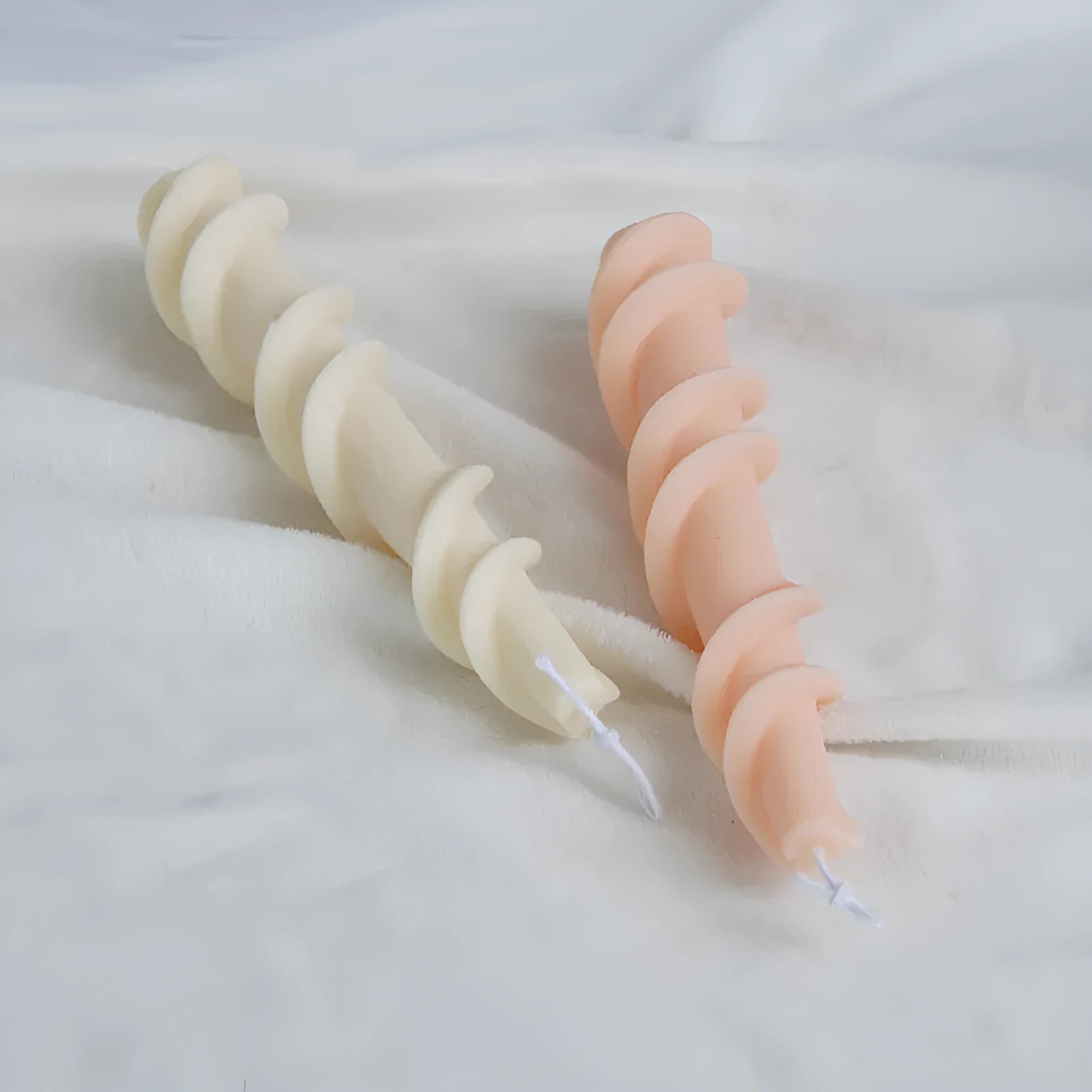 Close-up of a spiral lace rod silicone candle mould in photo colour for making textured pillar candles.