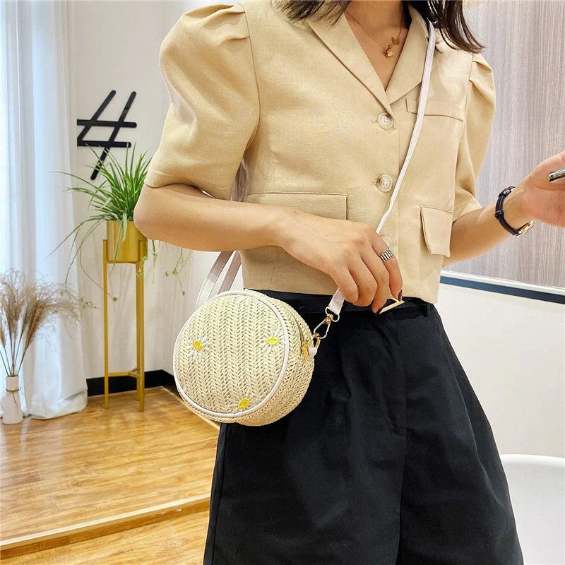 Straw woven small round bag with embroidered detail and smooth zipper