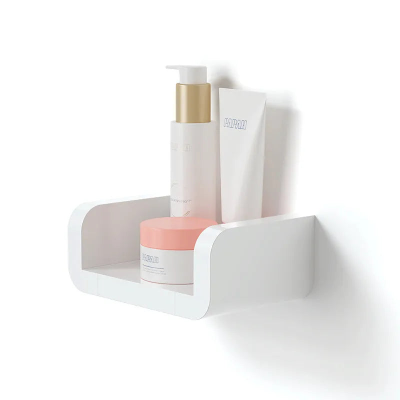 White plastic bathroom storage shelf mounted with suction cups on a tiled wall.