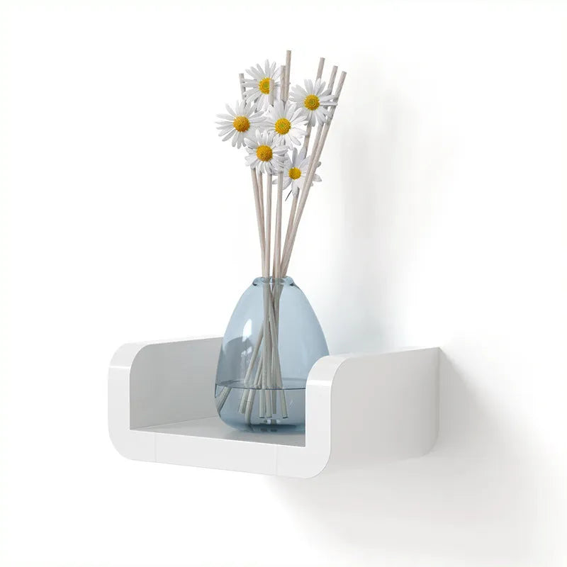 White plastic bathroom storage shelf mounted with suction cups on a tiled wall.