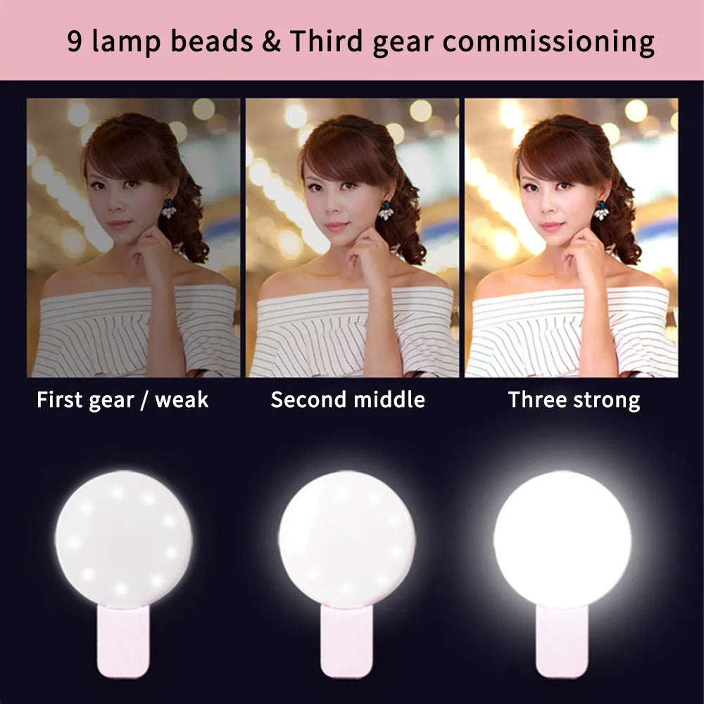 Small round white clip-on LED fill light attached to a mobile phone for selfies.