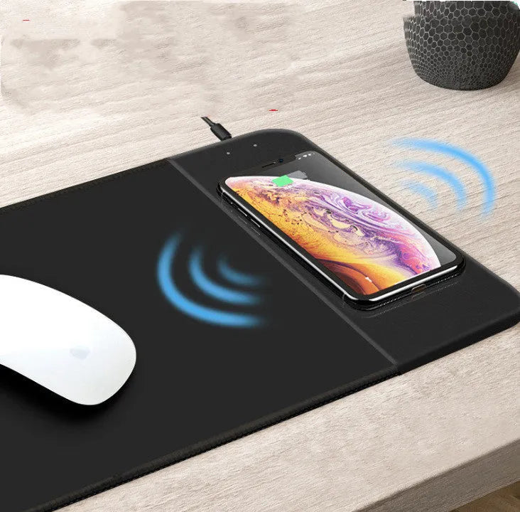Wireless charging mouse pad with RGB lighting and non-slip rubber base, measuring 298mm by 215mm by 5mm, featuring heat transfer cartoon designs and USB power connection.