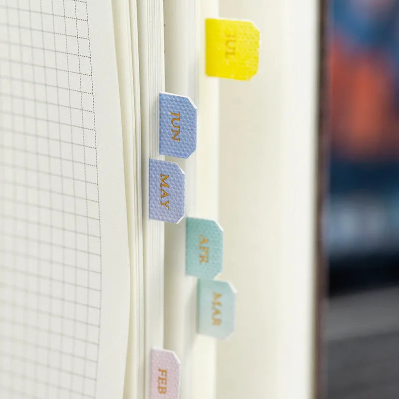 Ten sheets of Yunmu Morandi gradient label stickers in Elegant, Jazz, Neon, and Summer colours on a table.