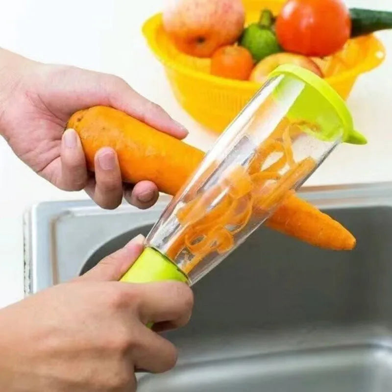 Green vegetable peeler with a transparent storage box attached, showing a stainless steel blade.
