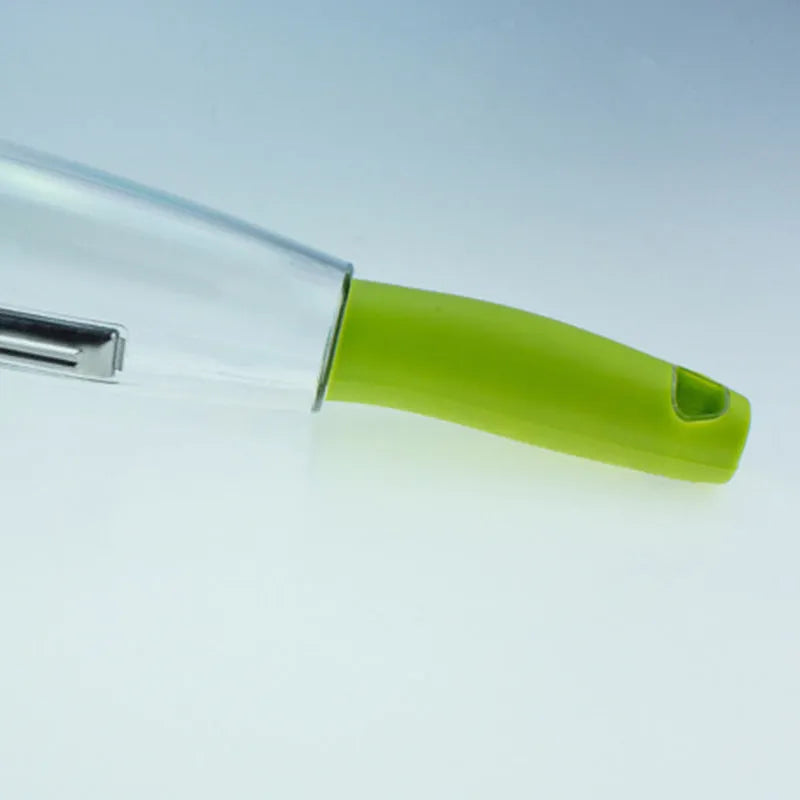 Green vegetable peeler with a transparent storage box attached, showing a stainless steel blade.