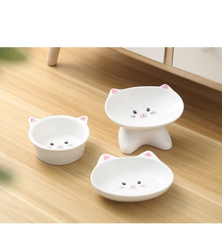White ceramic pet food bowl with raised cat face design for cats and small dogs