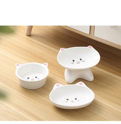 White ceramic pet food bowl with raised cat face design for cats and small dogs