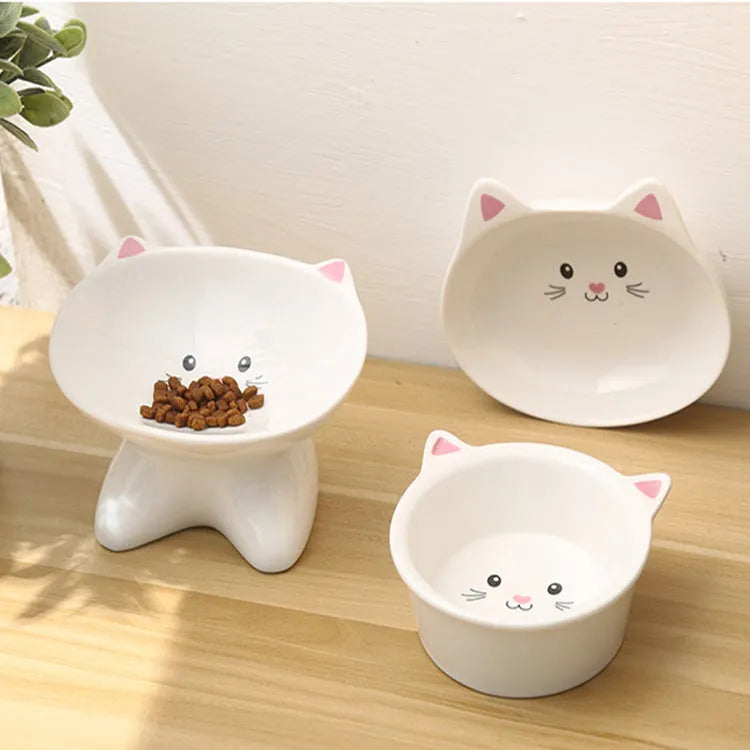 White ceramic pet food bowl with raised cat face design for cats and small dogs