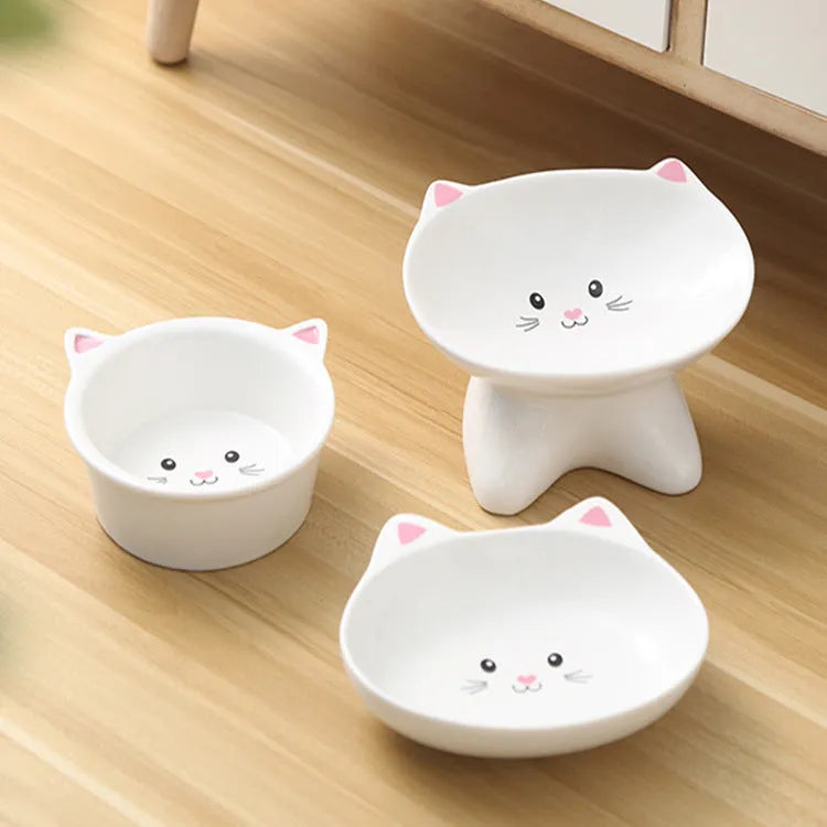 Ceramic pet food bowl featuring a small cat face shape design, suitable for cats and dogs, made from durable porcelain material with an easy-clean glazed surface, available in multiple colour options including black, for single or multi-pet households.