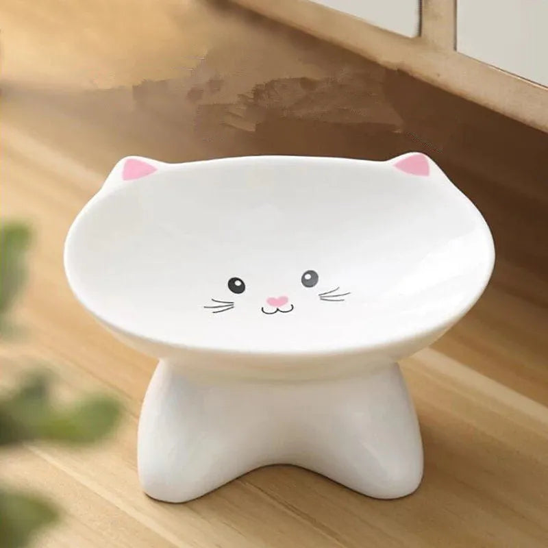 White ceramic pet food bowl with raised cat face design for cats and small dogs