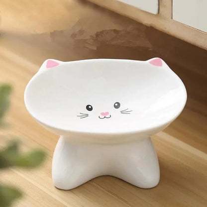 White ceramic pet food bowl with raised cat face design for cats and small dogs