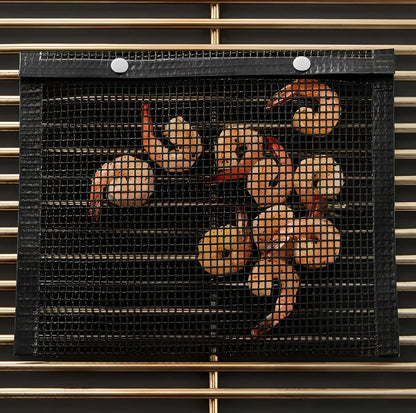 Black grill mesh bag with non-stick grid mat for BBQ cooking showing smoke-through design