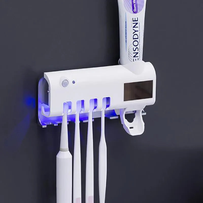 Black wall-mounted UV toothbrush steriliser with automatic toothpaste squeezer showing infrared sensor and solar panel