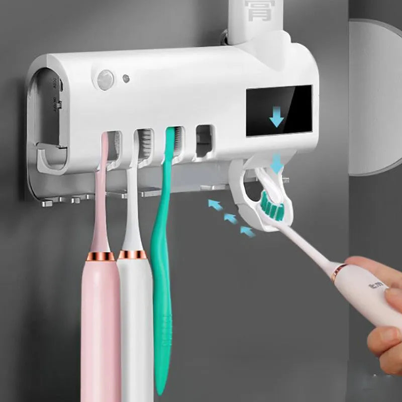 Black wall-mounted UV toothbrush steriliser with automatic toothpaste squeezer showing infrared sensor and solar panel