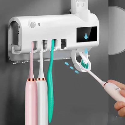 Black wall-mounted UV toothbrush steriliser with automatic toothpaste squeezer showing infrared sensor and solar panel