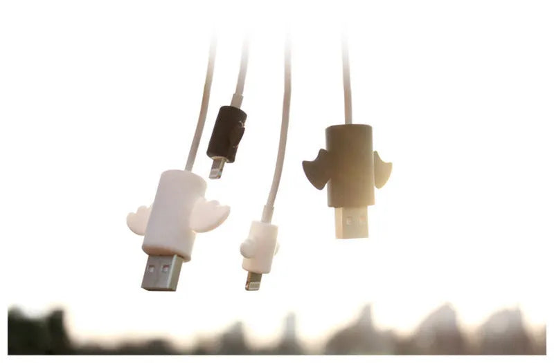 White and black silicone protective covers for mobile phone charging and data cables showing two size options