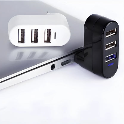 Black and white USB 2.0 hub splitter with spin colour casing on a desk next to a laptop.
