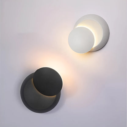 Rotating lunar eclipse LED wall lamp with aluminium shade, pull cord switch, black or white finish, for living room or bedside.