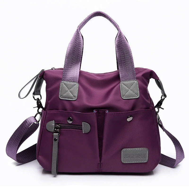 A fashionable and versatile ladies tote bag with multiple compartments and carrying options for the modern woman on the move.