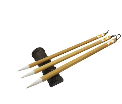 Three traditional Chinese calligraphy brushes with bamboo handles and wool bristles in large, medium, and small sizes.