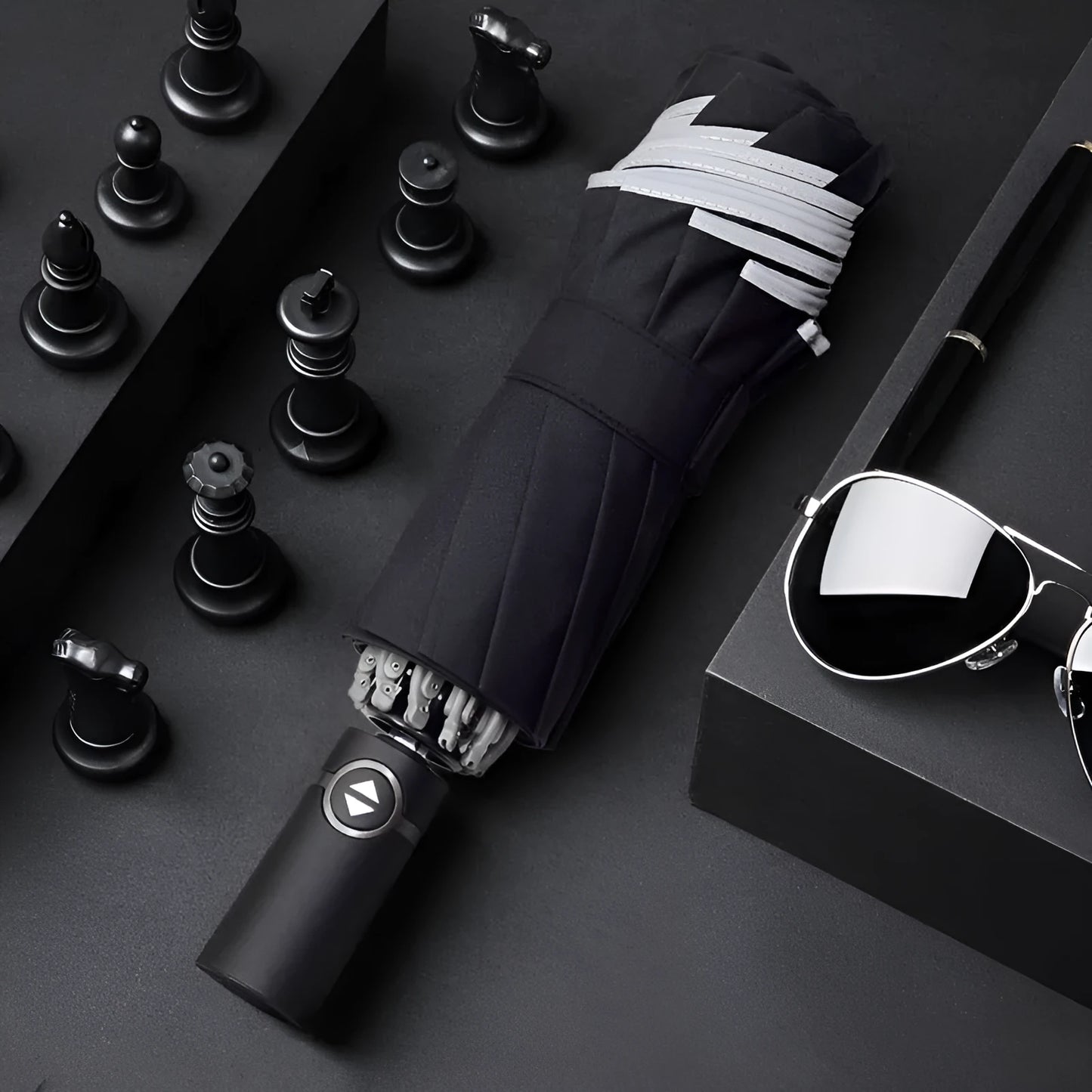 Black automatic reverse umbrella with reflective canopy showing three-fold design and plastic non-slip handle