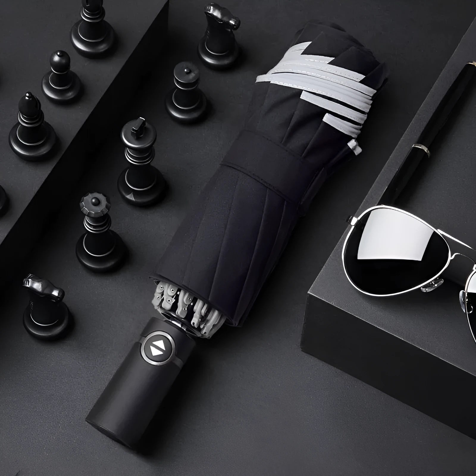 Black automatic reverse umbrella with reflective canopy showing three-fold design and plastic non-slip handle