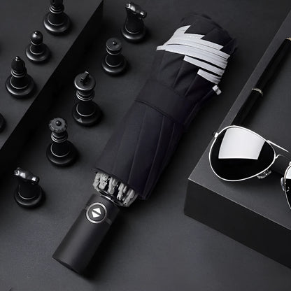 Black automatic reverse umbrella with reflective canopy showing three-fold design and plastic non-slip handle