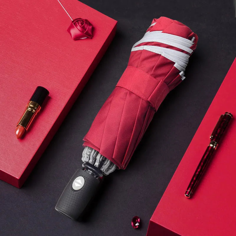 Black automatic reverse umbrella with reflective canopy showing three-fold design and plastic non-slip handle