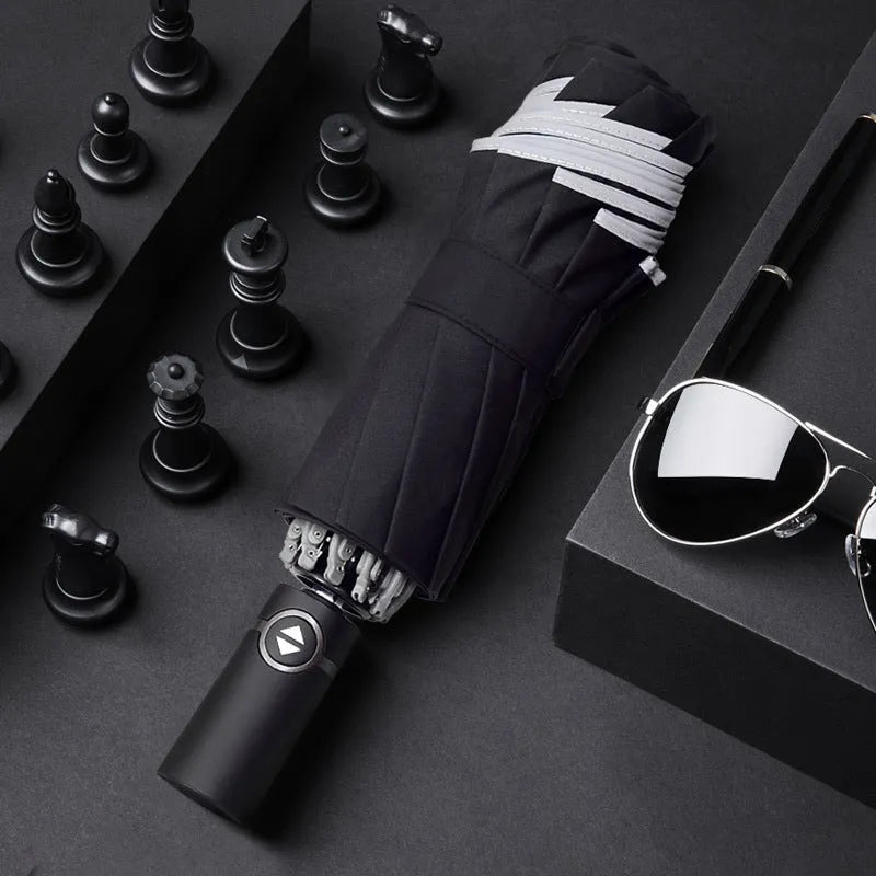Black automatic reverse umbrella with reflective canopy showing three-fold design and plastic non-slip handle