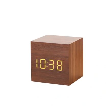 Wooden digital LED alarm clock on desktop with black finish showing time display