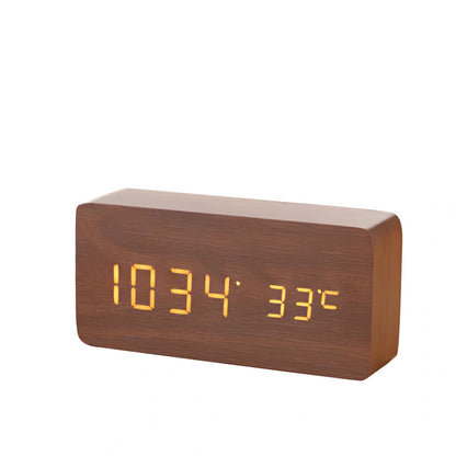 Wooden digital LED alarm clock on desktop with black finish showing time display