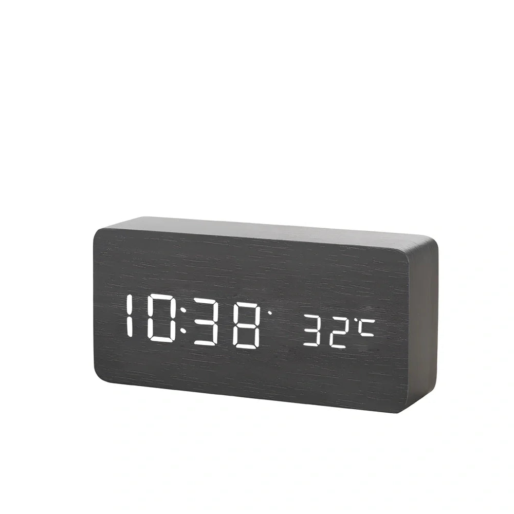 Wooden digital LED alarm clock on desktop with black finish showing time display