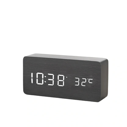 Wooden digital LED alarm clock on desktop with black finish showing time display