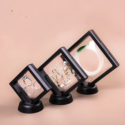 Black 11x11cm suspended 3D floating display frame holding a coin, with square base for stable collectible showcase