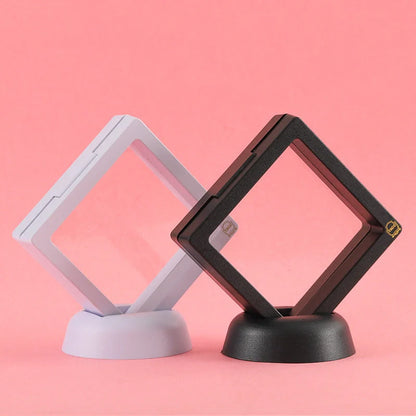 3D floating jewelry coin display stand in white and black, showcasing collectibles in mid-air