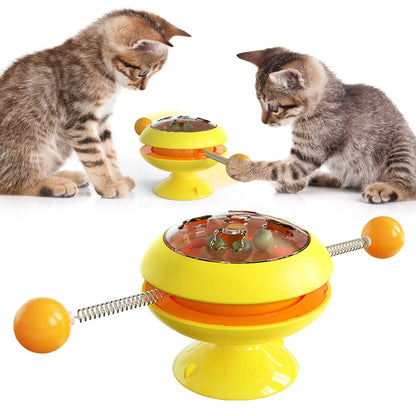 Rotating interactive cat toy with suction cup base and transparent catnip compartment