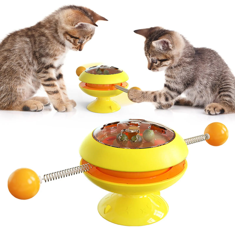 Rotatable interactive cat toy with suction cup base, catnip balls, and colourful plastic construction for indoor kitten training and play