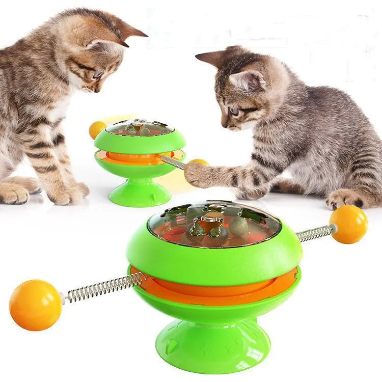 Rotating interactive cat toy with suction cup base and transparent catnip compartment