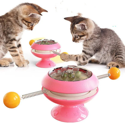 Rotating interactive cat toy with suction cup base and transparent catnip compartment
