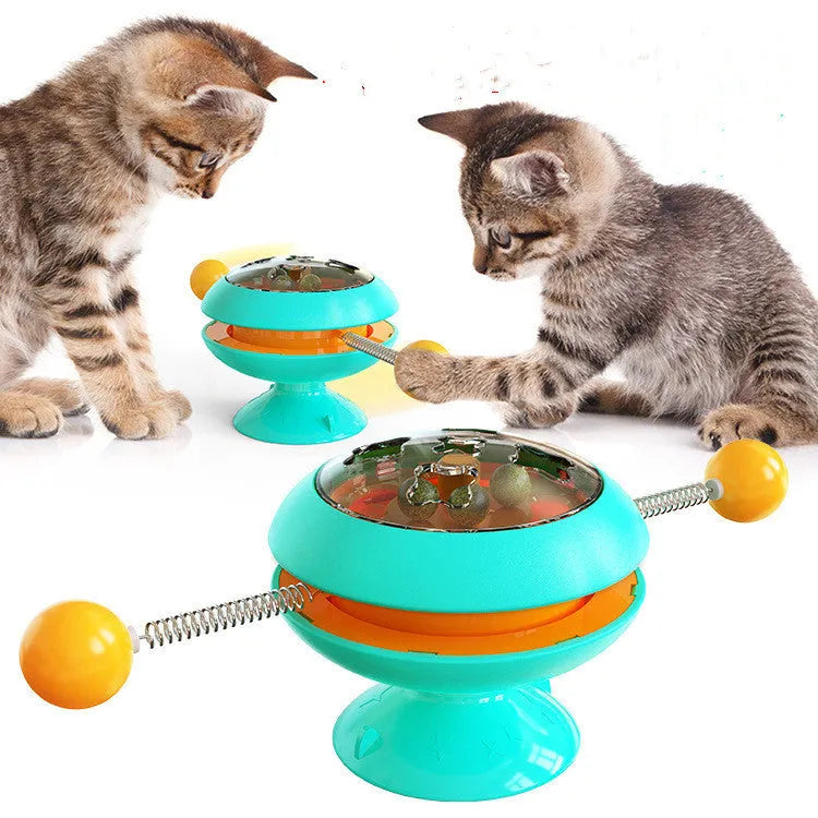 Rotating interactive cat toy with suction cup base and transparent catnip compartment