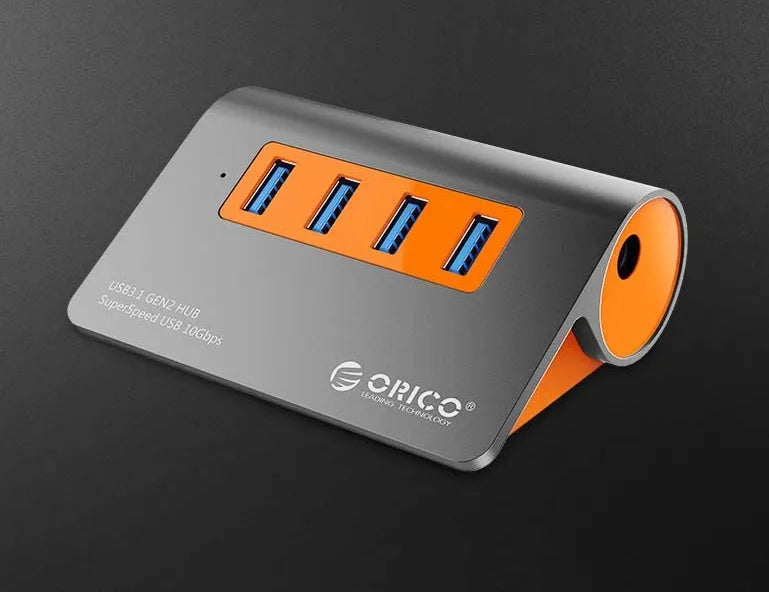 Dark grey and orange aluminium laptop hub with four USB ports, a blue LED light, and a detached cable.